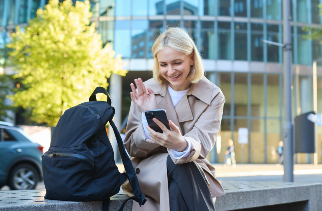 Roaming - kvinde vinker til sin mobil